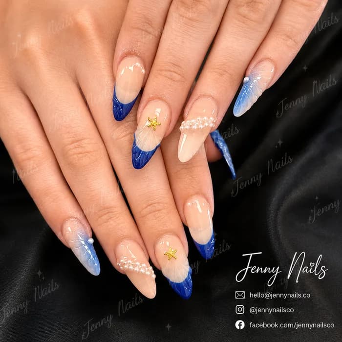 Blue ocean French nails with 3D flower accents at Elysian Nails & Spa in Green Valley, Arizona